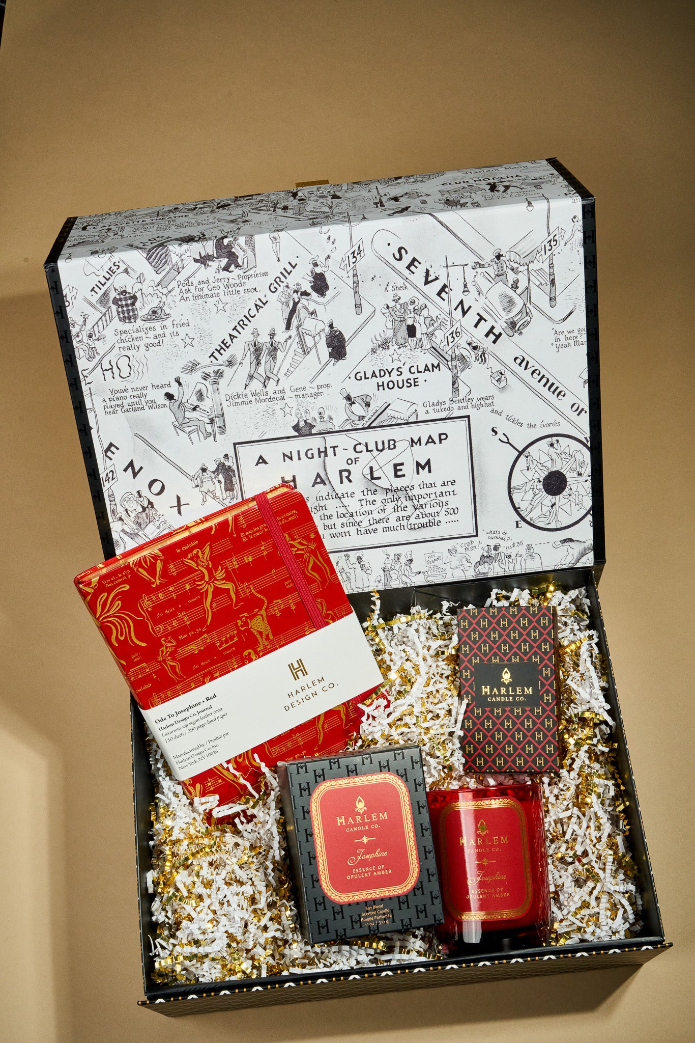 This is an image of our Josephine secrets gift box which include our 11 ounce Josephine candle, or red and gold, Josephine Journal, and our red and gold, gold art, deco, elegant matches.