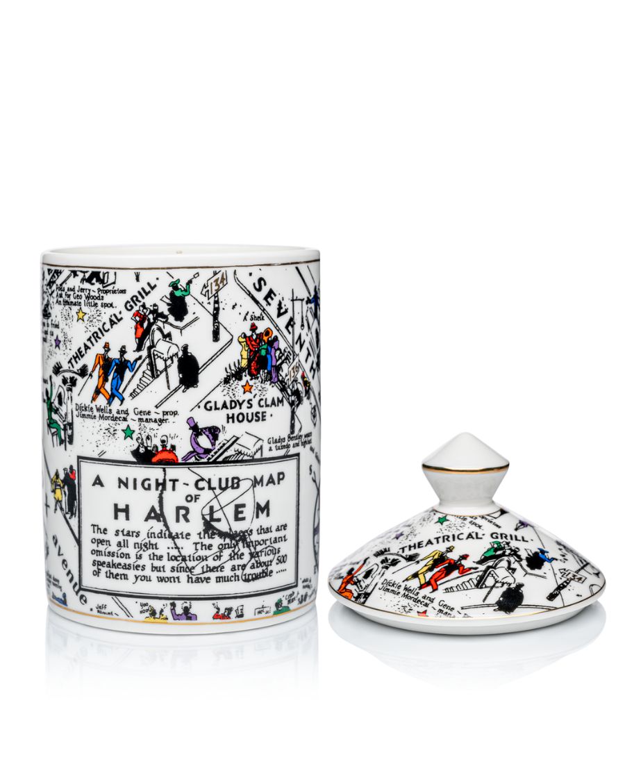 This is an image of our night club map of Harlem candle in black-and-white with pops of color. This candle has a dome lid and is Fragrance with the Langston scent.  In this image, the lid is positioned next to the candle versus on top