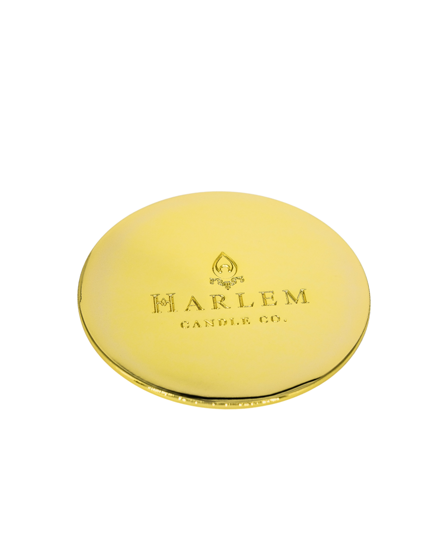 This is an image of our Harlem Candle Company gold candle lid on a white background.